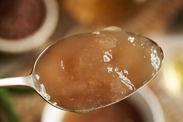 Homemade flax seed gel on a spoon - ingredient for natural diy shampoo. Alternative haircare, no poo.