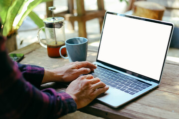 computer screen blank mockup.work using laptop with white background for advertising,contact business search information on desk at coffee shop.marketing and creative design