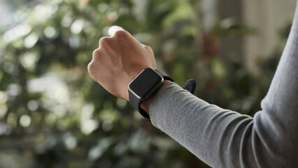 Modern smartwatch on wrist checking notifications and time, capturing the essence of smart technology and lifestyle
