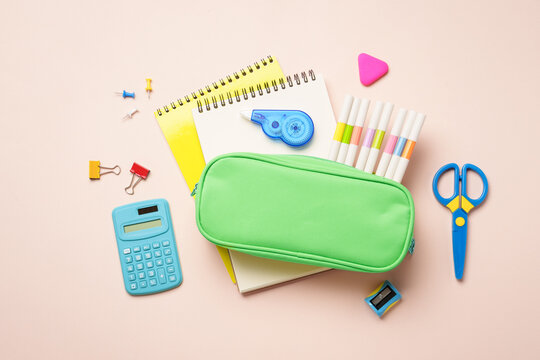 Pen il case, school supplies on colored background. Pencil case, notepads, markers, pens and others. Flat lay image on colored background. - Powered by Adobe