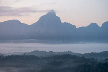 Mountain landscape with morning mist and forest in peaceful natural setting  at  Phadeng Peak, Luang Prabang, Laos