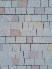 Texture of street tiles. Pattern of gray sidewalk tiles close up