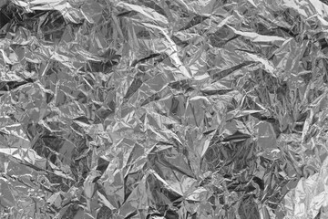 Silver crumpled foil texture on flat surface