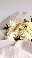 Golden snake among white peonies
