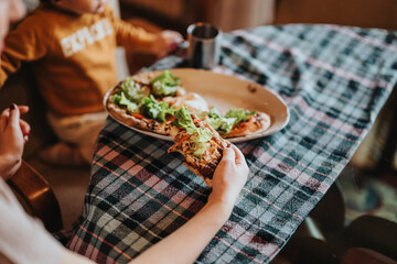 A warm and inviting family moment at home around a meal consisting of fresh pizza and salad pieces, accompanied by the charming setting of a cozy dining atmosphere.