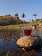 a glass of tea at the riverside