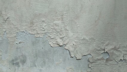 Distressed Wall with Peeling Paint, Revealing Underlying Layers and Textures, Gray Concrete Background Showing Decaying Surface Due to Age and Weathering