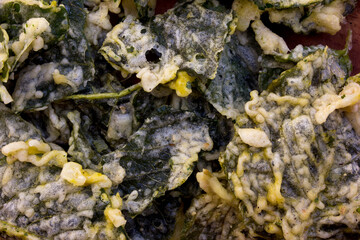 Chips made from spinach fried in flour, background and texture. This chip is a traditional snack from Indonesia.