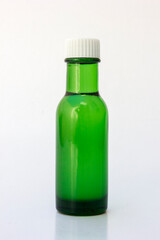 A green bottle of eucalyptus oil with white cap, isolated on white. Eucalyptus oil supports a healthy lifestyle by offering benefits such as respiratory relief, pain and inflammation reduction.