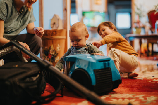 A heartwarming scene of family togetherness, children playing in a cozy home environment. Featuring a mother, her children, and a playful moment in an inviting and vibrant space.