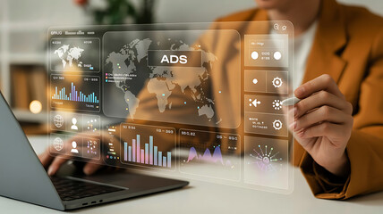 Modern professional using laptop with futuristic holographic interface displaying data and charts for innovation and growth