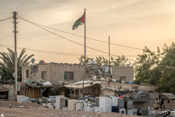 Fototapeta premium Flag of Palestine in a poor, underdeveloped area of the Middle East, during the conflict in Palestinian Gaza, among the ruins and debris. 