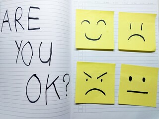 Mental health awareness Asking 'Are you OK?' with visual representations of emotional states on sticky notes