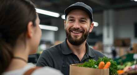 A cheerful grocery store employee handing a customer a bag of fresh vegetables.