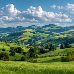 Fototapeta premium Lush green hills, scattered farms, blue sky, white clouds