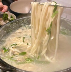 Warm and comforting kalguksu with hand-cut noodles in rich, savory broth, served with vegetables...