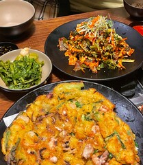Bunsik, a popular Korean street food, includes various dishes like tteokbokki, odeng, and gimbap. It's a tasty, comforting snack loved by many, perfect for casual gatherings or quick bites.