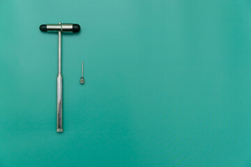 medical hammer and medical needle on green Background, Space for Text, Space for Logo