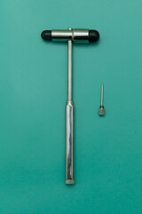 medical hammer and medical needle on green Background, Space for Text, Space for Logo