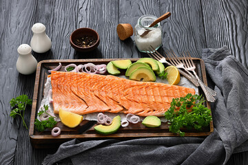 grilled whole salmon fillet on wooden board