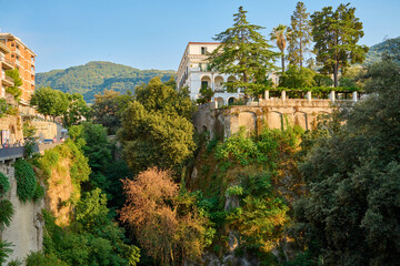 Fototapeta premium Coastal Cliffside Architecture, Trees, Sunny Day