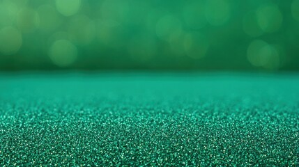 Vibrant emerald green glitter texture with sparkling bokeh background