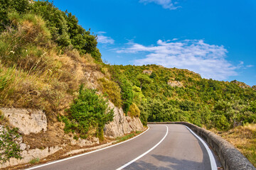 Winding Coastal Road, Scenic Green Landscape, Blue Sky