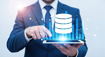 Businessman holding tablet displaying glowing database icon with futuristic digital data visualization and light effects