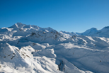 View of snow-capped mountains and blue sky on a sunny day