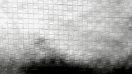 abstract closeup of metallic square tile texture with light and shadow for modern background or...
