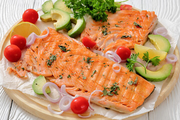grilled salmon fillet on circle wooden board