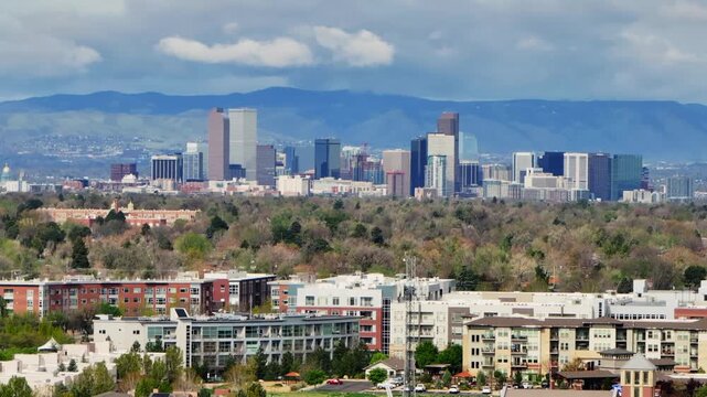 Downtown Denver skyscraper front range foothills landscape view aerial drone Colorado Northfield Stapleton Central Park spring morning rain clouds sunny cityscape Capitol building upwards motion