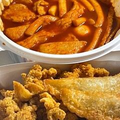 Spicy yeoptteok paired with crispy Korean fried chicken, combining fiery rice cakes and savory crunch for an irresistible duo that’s bold, satisfying, and full of Korean street food flavor.