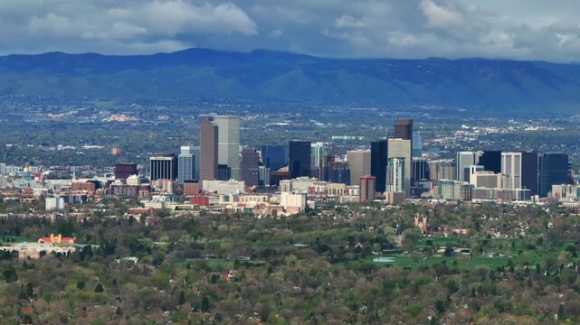 Downtown Denver skyscraper front range foothills landscape view aerial drone Colorado Northfield Stapleton Central Park spring morning rain clouds sunny cityscape Capitol building parallax circle left