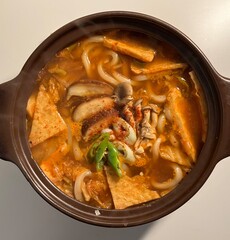 A warm bowl of udon noodles in a savory broth, topped with fresh scallions and tempura. This Japanese comfort food offers a perfect blend of chewy noodles and umami-rich flavors!