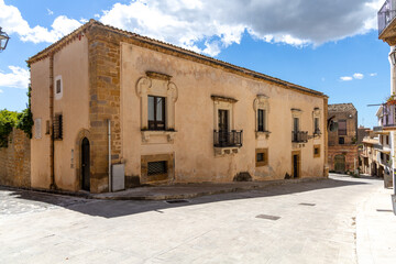 Fototapeta premium Traditional stone building on a quiet street corner in Sambuca di Sicilia, a historic hill town in Sicily in southern Italy.