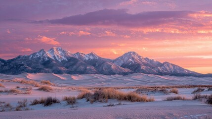 Sunrise over snowy mountains and dunes