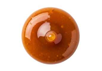 A circular, glossy caramel sauce droplet sits centered on a black background.