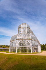 Greenhouse botanical in city of Curitiba, Brazil, with a metal framework and glass panels houses internal vegetation.