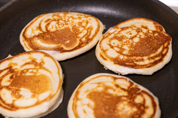 Shot of the pancakes on the frying pan. Food