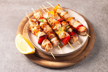 Grilled chicken skewers. Satay with side lemon and salad. Kebab with sauces. 
