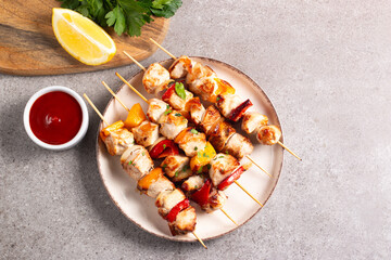 Grilled chicken skewers. Satay with side lemon and salad. Kebab with sauces. 