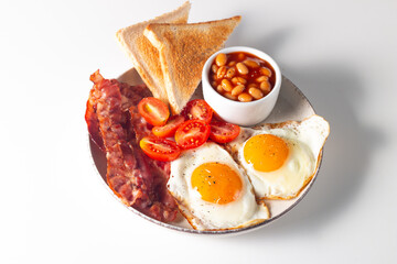 Delicious traditional English breakfast with fried eggs and bacon