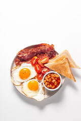 Delicious traditional English breakfast with fried eggs and bacon