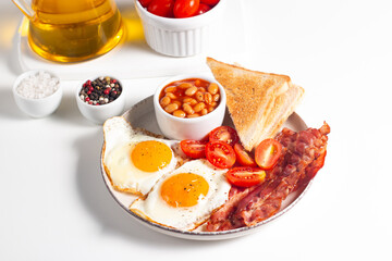 Delicious traditional English breakfast with fried eggs and bacon