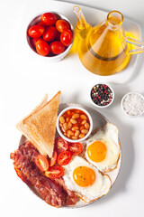 Delicious traditional English breakfast with fried eggs and bacon