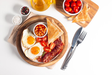 Delicious traditional English breakfast with fried eggs and bacon