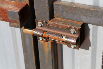 an iron rusty bolt on a metal door