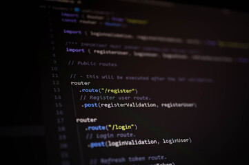 Close-up of JavaScript backend code showing user authentication routing for register and login endpoints using Express framework in a modern web application.