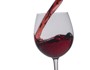 A glass filled with red wine, showcasing a vibrant pour that creates dynamic splashes and bubbles.